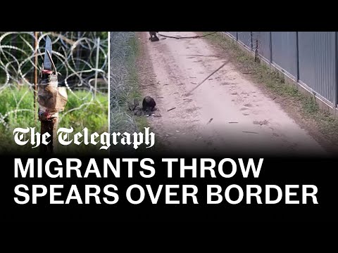 Migrants throw makeshift spears at Polish border guards